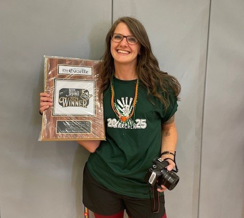 Joann Cassano holding her Best High School Educator award. 